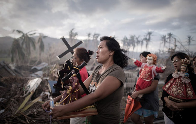 Survivors of typhoon Haiyan form a religious procession in the village of Tolosa in the eastern Philippines. (AFP Photo/ Philippe Lopez)