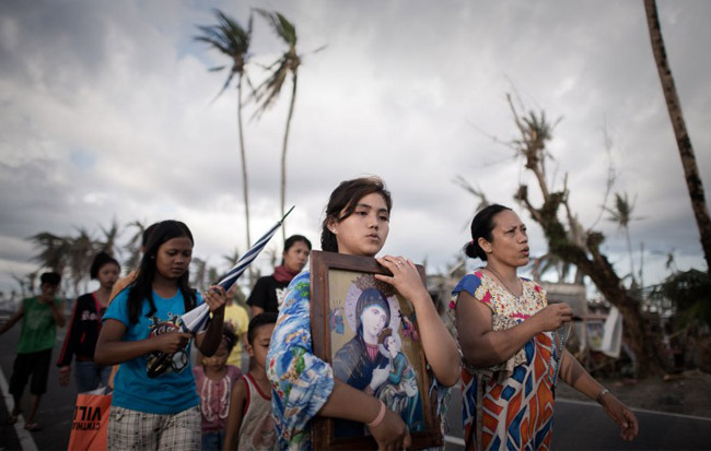 Survivors of Super Typhoon Haiyan form a religious procession in the village of Tolosa. (AFP Photo / Philippe Lopez)