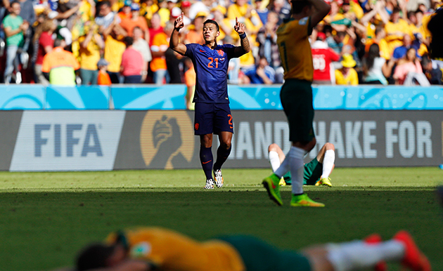 Netherlands' Memphis Depay celebrates his team's 3-2 victory over Australia during the group B World Cup soccer match between Australia and the Netherlands at the Estadio Beira-Rio in Porto Alegre, Brazil, Wednesday, June 18, 2014. (AP Photo/Jon Super)