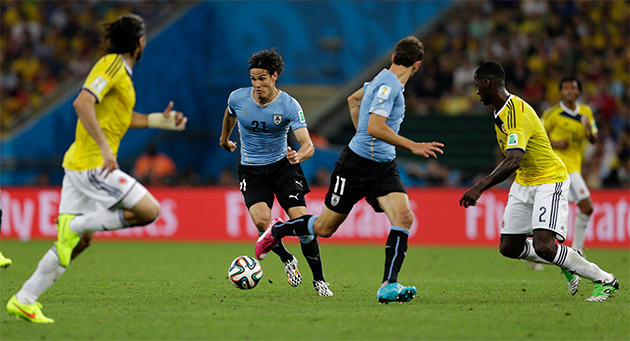 Uruguay's Edinson Cavani runs with the ball during the World Cup round of 16 soccer match between Colombia and Uruguay at the Maracana Stadium in Rio de Janeiro, Brazil, Saturday, June 28, 2014. (AP Photo/Natacha Pisarenko)