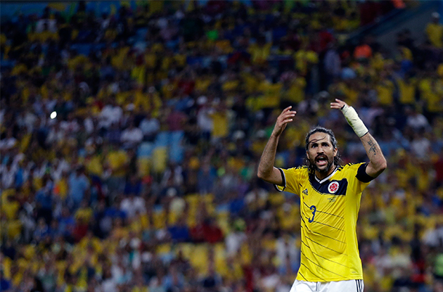 Colombia's Mario Yepes rouses the crowd during the World Cup round of 16 soccer match between Colombia and Uruguay at the Maracana Stadium in Rio de Janeiro, Brazil, Saturday, June 28, 2014. (AP Photo/Natacha Pisarenko)