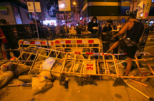 Pro-democracy protesters fortify barricades in a blocked-off intersection of Mong Kok district of Hong Kong, China just minutes after midnight on 13 October 2014.