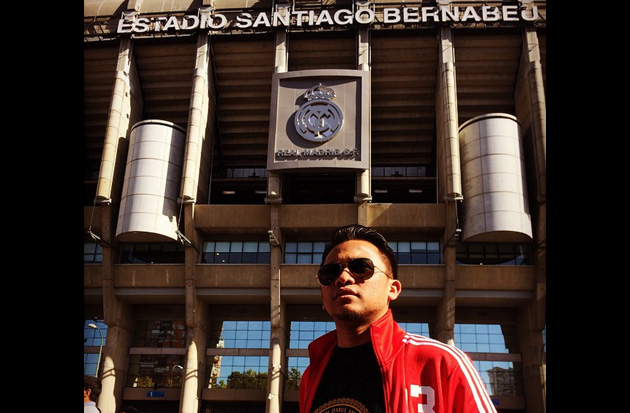 IM Asyraf poses in front of the Santiago Bernabeu Stadium where the match took place.