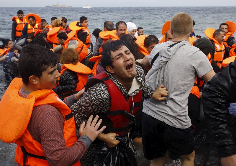 A Syrian refugee cries while disembarking from a flooded raft at a beach on the Greek island of Lesbos, after crossing a part of the Aegean Sea from the Turkish coast on an overcrowded raft, October 20, 2015. REUTERS/Yannis Behrakis