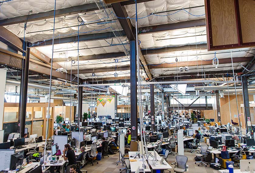 Employees can be seen on September 25 inside Facebook's Menlo Park, California, office, which may be the longest continuous work space in the world. Photo by Nick Otto for The Washington Post
