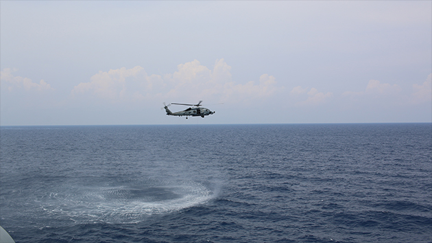 A Sea Hawk helicopter hovering over the South China Sea.