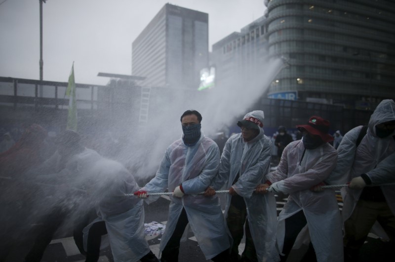 Water mixed with tear gas liquid is sprayed by police water canon to disperse protesters during an anti-government rally in central Seoul, South Korea, November 14, 2015. REUTERS/Kim Hong-Ji