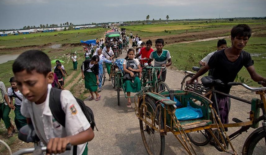 In this Oct. 13, 2015 photo, Rohingiya children travel in rickshaws in Thet Kabyin village, north of Sittwe, western Rakhine State, Myanmar. 