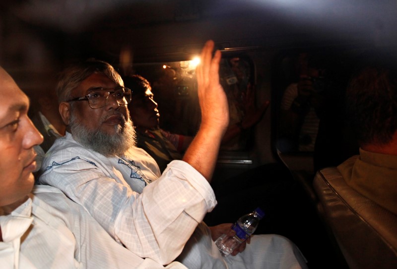 Ali Ahsan Mohammad Mujahid waves from a car as police arrest him in Dhaka in this file June 29, 2010 photo. REUTERS/Andrew Biraj