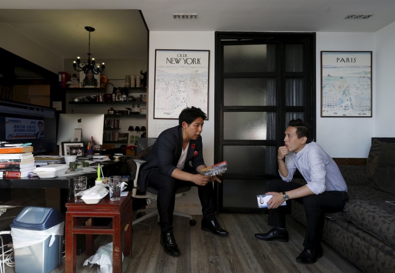 Edward Lau (L), 29, and Steve Ng Wing-tat, 31, both Occupy Central protesters in 2014 and running for the upcoming district elections, talk at Lau's office in Hong Kong, China November 11, 2015. REUTERS/Bobby Yip