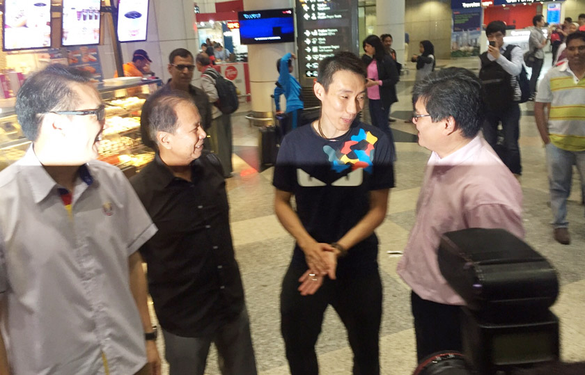 A high-spirited Chong Wei (third, left) talking to BAM's Kenny Goh (right) at the KLIA Wednesday evening. - Photo by Zan Azlee