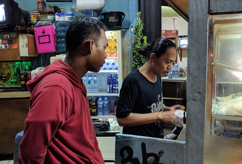 Fiki, 18, pelanggan tetap warung Pak Udin, bekerja sebagai anggota keselamatan di Hotel Indonesia. - Foto Karim Raslan