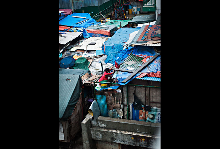 Locals often refer to slum houses as squatter homes as the makeshift structures are built on public property. - Photo by Karim Raslan