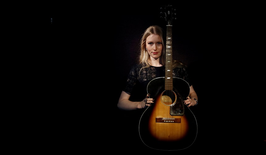 A Bonhams assistant displays an Epiphone FT79 Acoustic Guitar owned and played by Jimi Hendrix in central London, Britain December 12, 2016. REUTERS/Stefan Wermuth