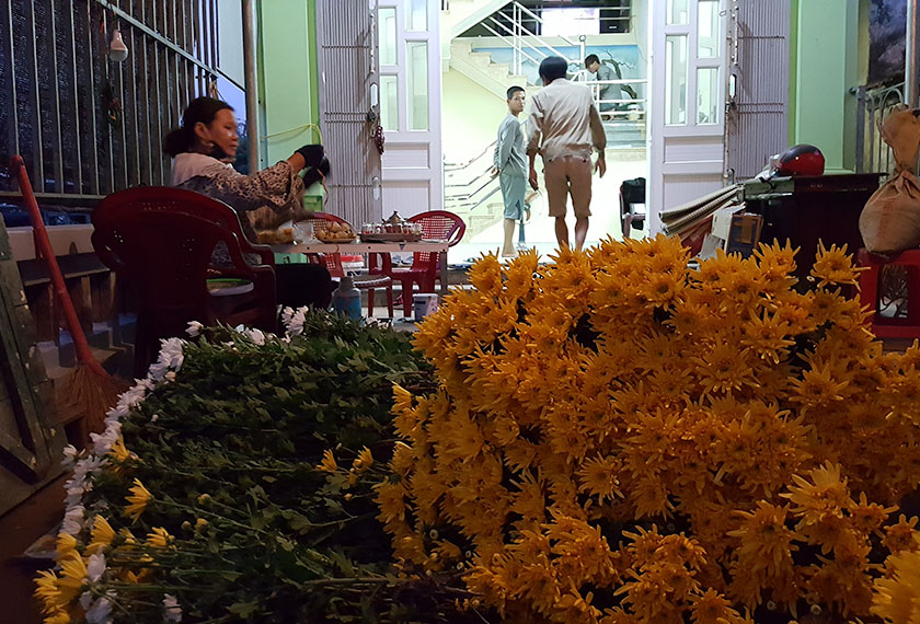 Vendors preparing flowers to sell at the night market. - Photo by Karim Raslan