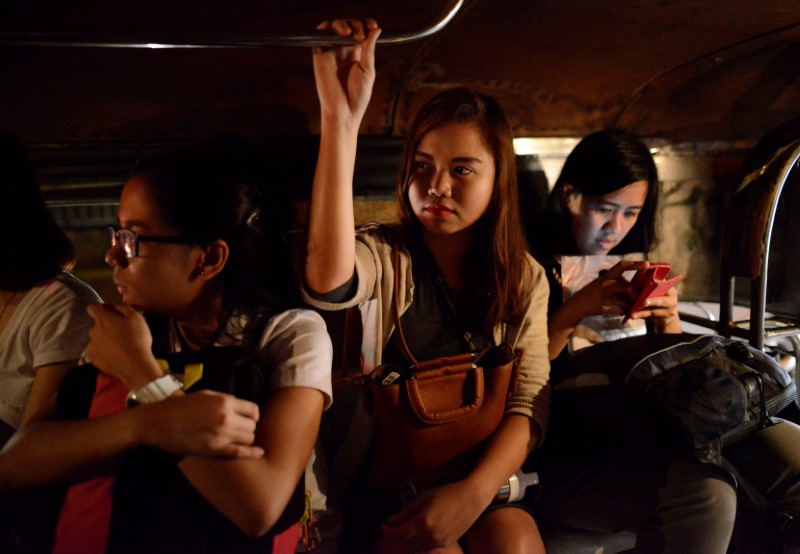 Cristine Angelie Garcia (C), 24, rides a jeepney on her way to work at a call centre for the midnight shift in Taguig city, Metro Manila, Philippines October 3, 2016. 