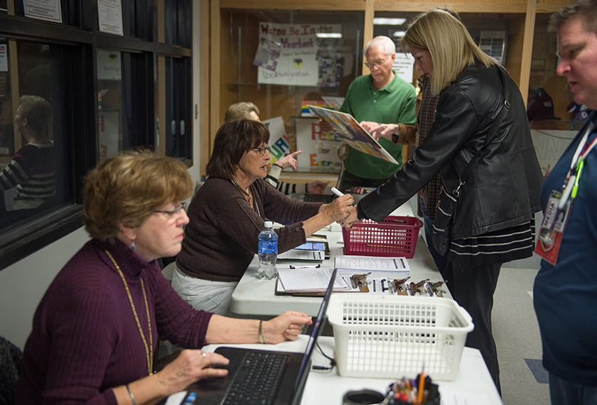 A caucus worker checks in a voter prior to the Republican Party Caucus at Keokuk High School on February 1, 2016 in Keokuk, Iowa.