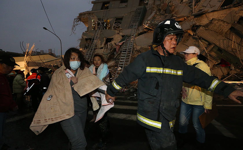 Rescue personnel carry a survivor at the site of a collapsed building in the southern Taiwanese city of Tainan following a strong 6.4-magnitude earthquake. -  AFP / Johnson Liu