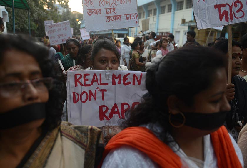 Indian demonstrators hold placards as they take part in a vigil and silent protest against the alleged gang-rape of a nun in the eastern state of West Bengal in Siliguri on March 17, 2015. The elderly nun was gang-raped at her convent school. - AFP Photo/Diptendu Dutta