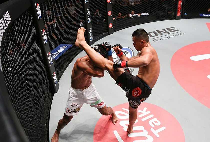 Loal hero Ev 'ET' Ting landing a kick to the head to his Filipino opponent, Eric 'The Natural' Kelly at ONE: Clash Of Heroes, Friday night. - ONE photo