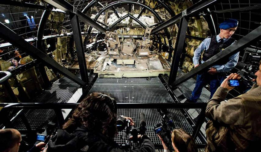 A view of the rebuilt cockpit section of the rebuilt fuselage of MH17 during a press conference to present the report findings of the Dutch Safety Board in Gilze Rijen, The Netherlands, on Oct 13, 2015. - EPA
