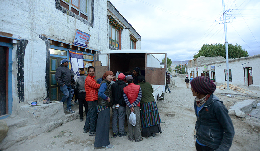In this June 15, 2016 photo, a crowd gathers to purchase groceries from a mobile jeep shop in the walled capital of Lo Manthang in Upper Mustang. - AFP Photo/Prakash Mathema