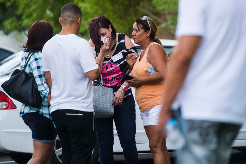 Friends and family mourn outside the Hampton Inn & Suites near the Orlando Regional Medical Center in Orlando, Fla. Amanda Voisard/ The Washington Post.