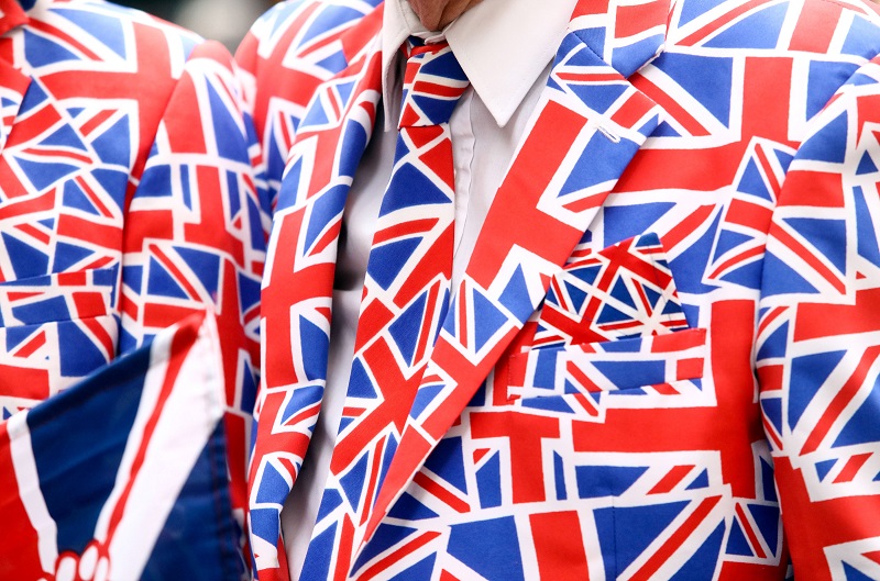 A pedestrian wears a suit, featuring the pattern of a British Union flag, commonly known as a Union Jack, in London on Friday, June 10, 2016. Bloomberg photo by Chris Ratcliffe.
