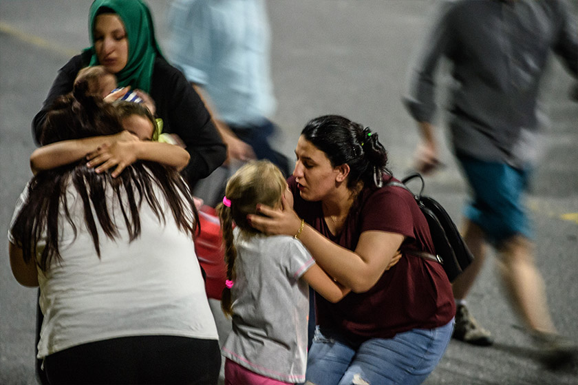 Children and their relatives embrace as they leave Ataturk airport on June 28, 2016 in Istanbul after two explosions followed by gunfire hit Turkey's biggest airport. - AFP