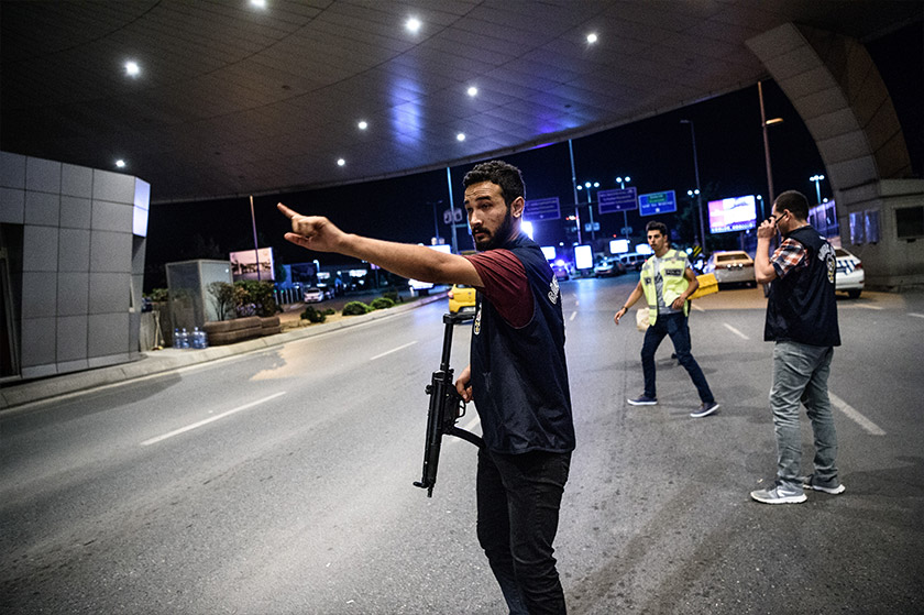 A Turkish police officer reacts at Ataturk airport`s main gate on June 28, 2016 in Istanbul after two explosions followed by gunfire hit Turkey's biggest airport. - AFP