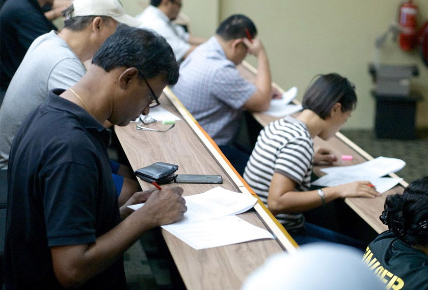 Parents sitting for the INTI SPM Quiz to win exclusive '5 Seconds of Summer' tickets for their children. - INTI photo.