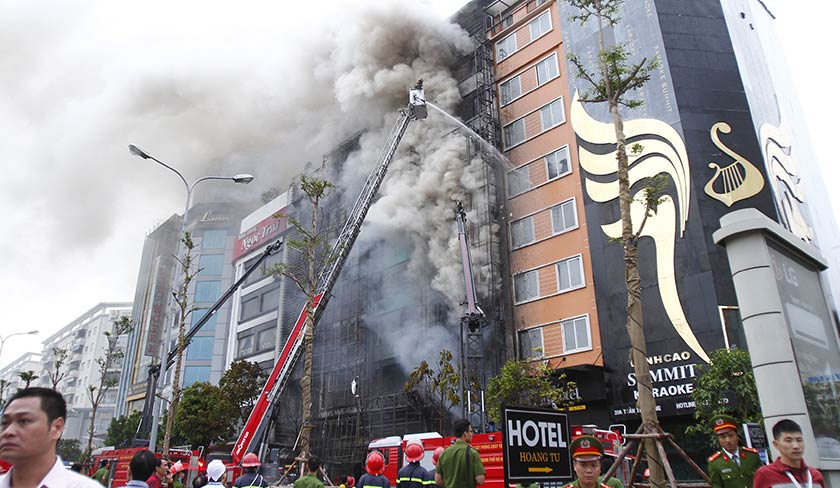 This photo taken on Nov 1, 2016 shows firefighters battling a fire at a karaoke bar in Hanoi. - AFP