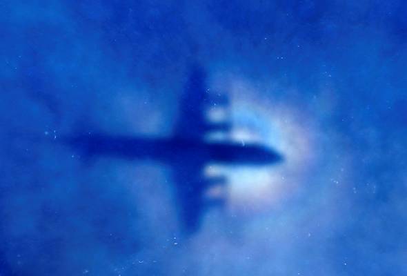 The shadow of a Royal New Zealand Air Force P3 Orion maritime search aircraft can be seen on low-level clouds as it flies over the southern Indian Ocean looking for flight MH370 on March 31, 2014. - Reuters