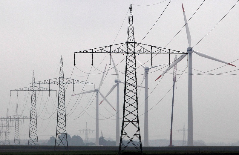 Maintenance work is done on a Vestas wind turbine (R) at a wind energy park near Heide, Germany, September 9, 2010. REUTERS/Christian Charisius/File Photo