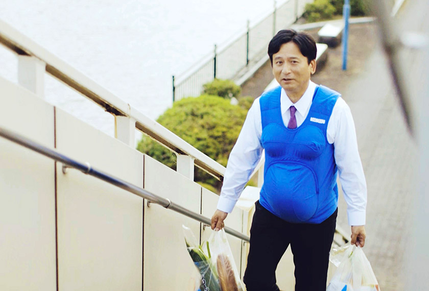 This video grab taken from footage released by Kyushu-Yamaguchi Work Life Balance Promotion Campaign on Oct 3, 2016 shows the governor of Saga prefecture, Yoshinori Yamaguchi, walking up stairs with a pregnancy vest. - AFP