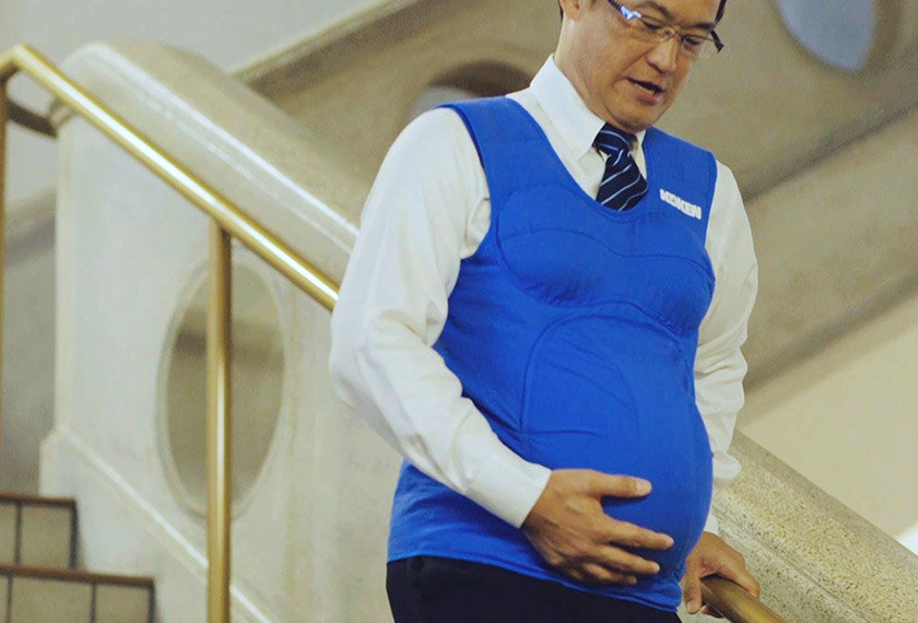 This video grab taken from footage released by Kyushu-Yamaguchi Work Life Balance Promotion Campaign on Oct 3, 2016 shows the governor of Miyazaki prefecture, Shunji Kono, walking down the stairs with a pregnancy vest. - AFP