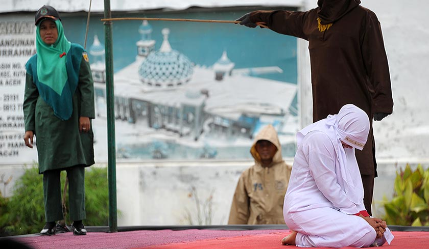 Out of seven couples caught spending time together outside marriage, 13 were caned while one woman was spared after it was discovered that she was pregnant. - AFP