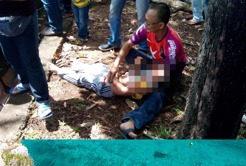 Muhammad Izz Danial being cradled as he waits for medical attention.