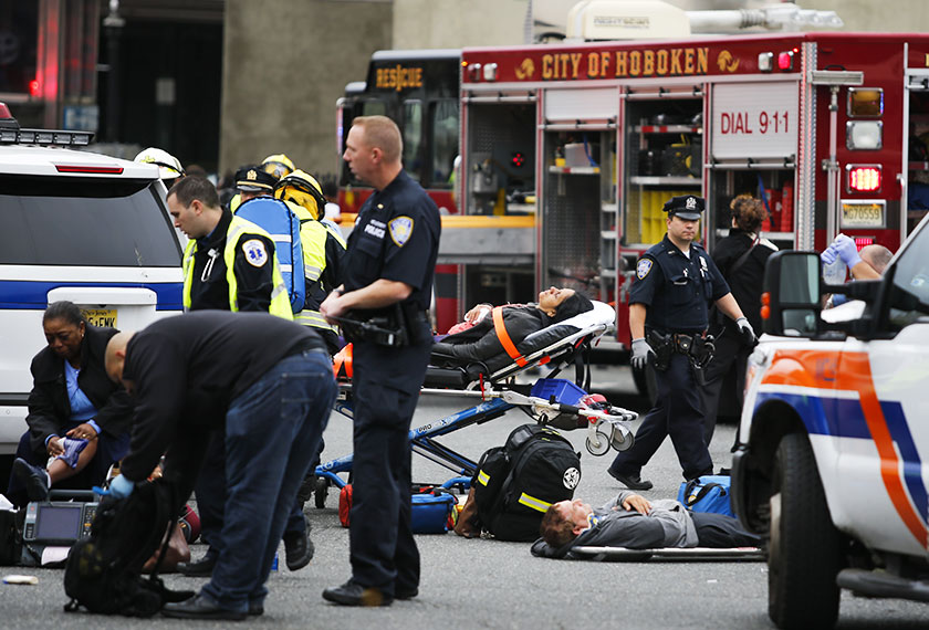 irst responders treat injured passengers after a New Jersey Transit train crashed into the platform at Hoboken Terminal during morning rush hour Sept 29, 2016 in Hoboken, New Jersey. - AFP