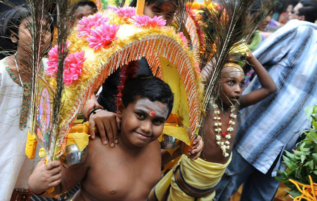 Thousands of Hindus carry kavadis as offerings to the Lord during Thaipusam.