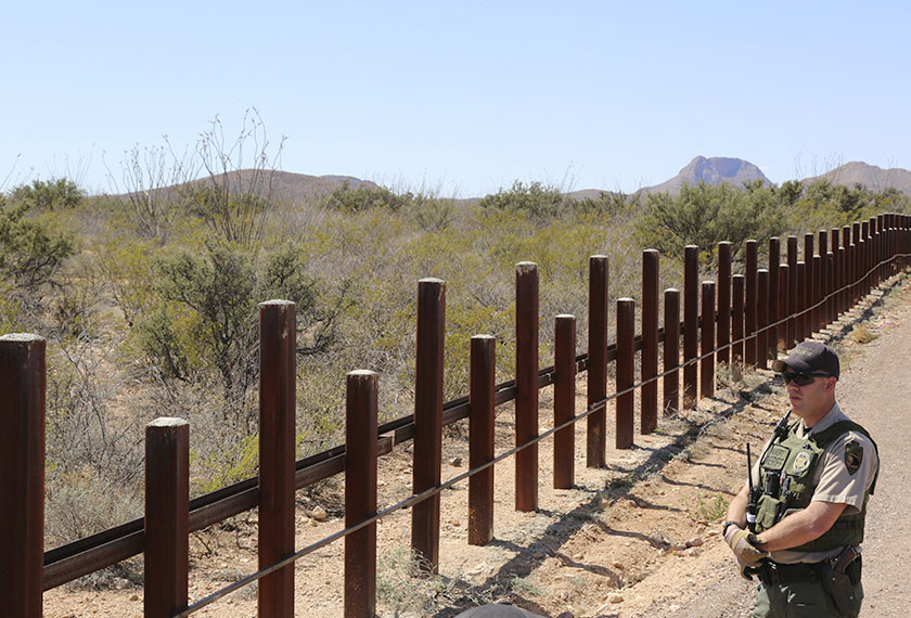 A worker stands next to a newly built section of the U.S.-Mexico border fence at Sunland Park, U.S. 