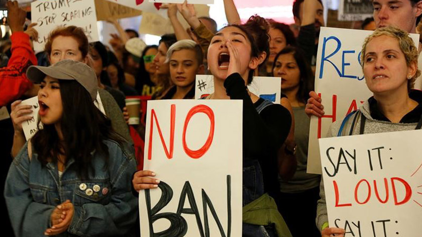 Demonstrators yell slogans during protest against the travel ban imposed by Donald Trump's executive order.