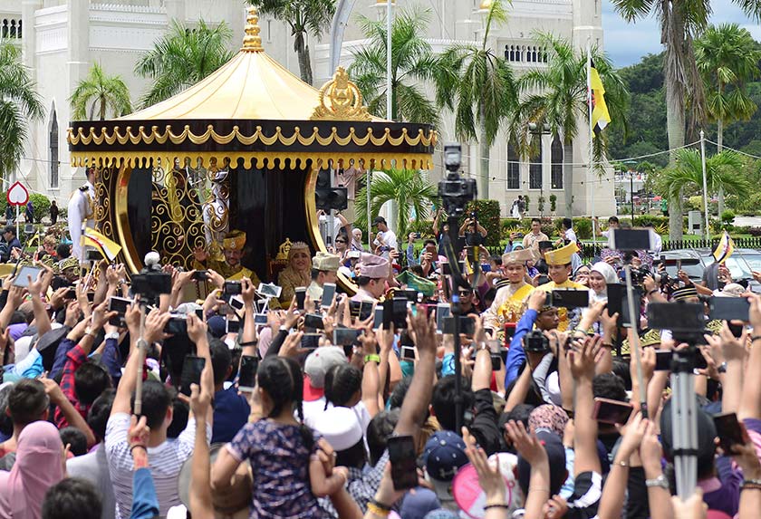 Brunei's Sultan Hassanal Bolkiah waves to people as he passes in a procession to mark his golden jubilee of his accession to the throne in Bandar Seri Begawan on Oct 5, 2017. - REUTERS