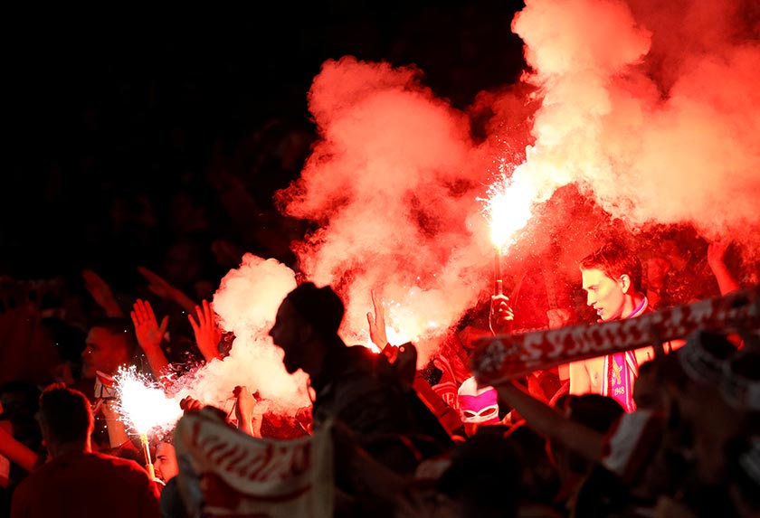 FC Cologne fans celebrate their first goal by letting off flares at the Emirates Stadium in London on Sept 14, 2017. - REUTERS