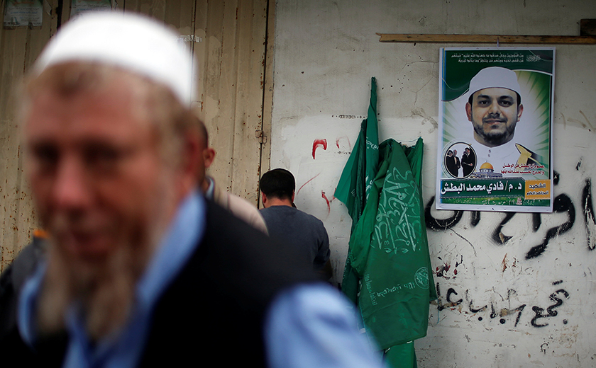 Poster Dr Fadi tergantung pada dinding kediaman keluarganya di Semenanjung Gaza. -Reuters