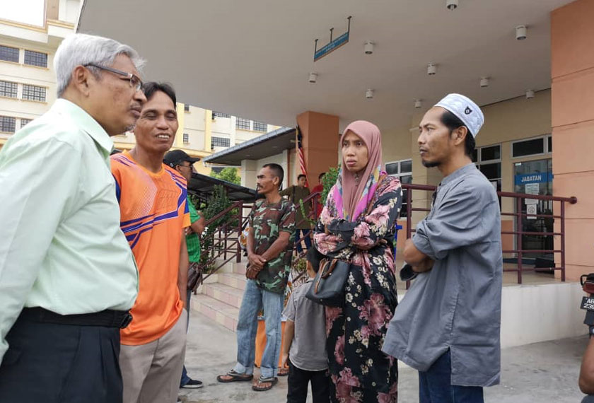 Abdul Aziz (kiri) bertemu sebahagian ahli keluarga dan waris mangsa yang terlibat dalam kebakaran rumah kedai di kawasan perindustrian Puncak Jelapang Maju, Meru, Ipoh pada Selasa. Astro AWANI