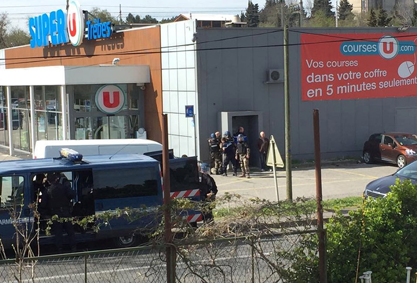 Police at the scene of a hostage situation in a supermarket in Trebes, Aude, France March 23, 2018 in this picture obtained from a social media video. - LA VIE A TREBES/via REUTERS