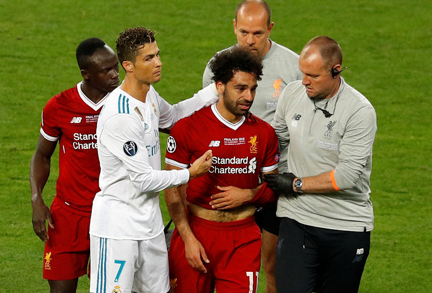 Liverpool's Mohamed Salah with Sadio Mane and Real Madrid's Cristiano Ronaldo as he is substituted after sustaining an injury. - REUTERS