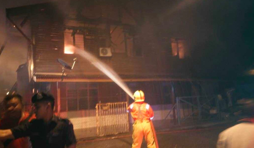 Anggota bomba sedang memadamkan kebakaran di salah sebuah rumah di Kampung Baru Cina Repas, Bentong, awal pagi ini. - Foto ihsan JBPM
