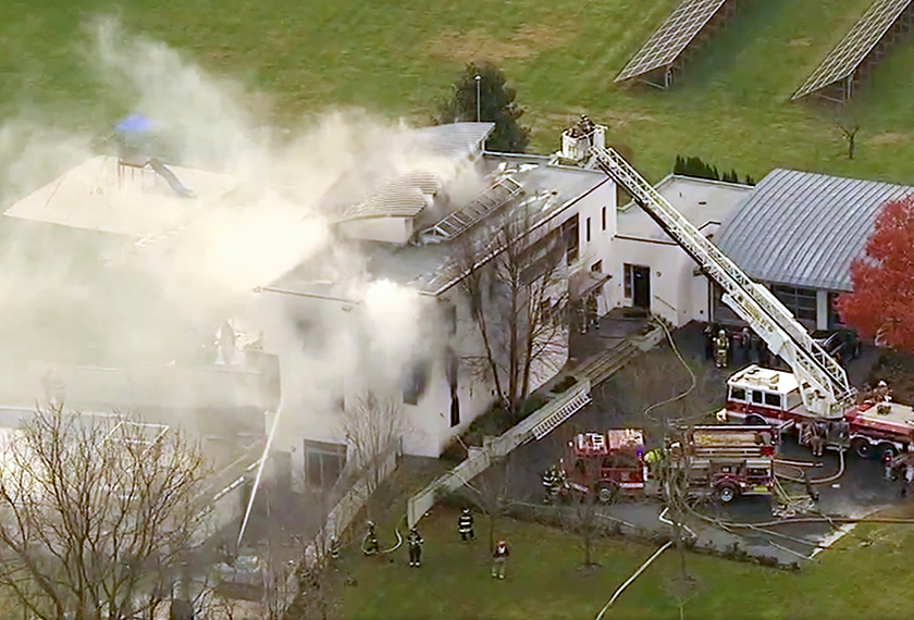 Kepulan asap keluar dari arah bumbung rumah agam dua tingkat itu. - Foto AP
